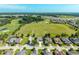 Aerial view of houses next to a golf course with lush trees and green spaces at 5093 Nw 35Th Lane Rd, Ocala, FL 34482