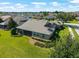 A beautifully landscaped backyard with a screened-in porch offers a perfect outdoor living space at 5093 Nw 35Th Lane Rd, Ocala, FL 34482