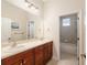 Bathroom with double sinks, dark cabinets and a shower/tub combo at 5093 Nw 35Th Lane Rd, Ocala, FL 34482