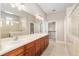 Bright bathroom featuring double sinks, long vanity, and glass enclosed shower and walk in closet at 5093 Nw 35Th Lane Rd, Ocala, FL 34482