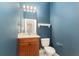 Modern half bathroom featuring navy walls, vanity, and updated fixtures at 5093 Nw 35Th Lane Rd, Ocala, FL 34482