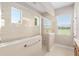 Lovely bright shower with glass door, tile surround, and a window with a view to the backyard at 5093 Nw 35Th Lane Rd, Ocala, FL 34482