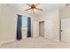 Bright bedroom featuring a ceiling fan, closet and a window with black out curtains at 5093 Nw 35Th Lane Rd, Ocala, FL 34482