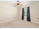 Bedroom with carpeted floors, neutral walls, and a window with dark curtains at 5093 Nw 35Th Lane Rd, Ocala, FL 34482