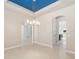 Open dining room with tile flooring and a unique blue tray ceiling at 5093 Nw 35Th Lane Rd, Ocala, FL 34482