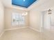 Dining room showcasing plantation shutters, tile flooring, and a unique blue accent ceiling at 5093 Nw 35Th Lane Rd, Ocala, FL 34482