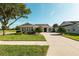 Charming home with lush green lawn, mature trees, and a well-manicured landscape at 5093 Nw 35Th Lane Rd, Ocala, FL 34482
