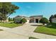 Traditional home boasting a manicured lawn, mature landscaping, and a paved driveway at 5093 Nw 35Th Lane Rd, Ocala, FL 34482