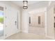 Bright foyer featuring neutral tile flooring and views to the adjacent room with large built-in cabinetry at 5093 Nw 35Th Lane Rd, Ocala, FL 34482