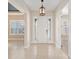A bright and open foyer with tile flooring and a view of rooms with plantation shutters at 5093 Nw 35Th Lane Rd, Ocala, FL 34482