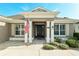 Elegant front entrance with decorative columns, shutters, and an American flag at 5093 Nw 35Th Lane Rd, Ocala, FL 34482