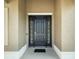 Close up of front door featuring sidelights, a door knocker, and a neutral exterior at 5093 Nw 35Th Lane Rd, Ocala, FL 34482