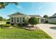 A well-manicured front yard with lush landscaping, showcasing the home's attractive curb appeal at 5093 Nw 35Th Lane Rd, Ocala, FL 34482