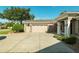 Home with attached two-car garage and paved driveway, surrounded by manicured landscaping at 5093 Nw 35Th Lane Rd, Ocala, FL 34482