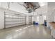 Brightly lit garage with epoxy floor, built-in work bench, and ample room for multiple vehicles at 5093 Nw 35Th Lane Rd, Ocala, FL 34482