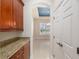 Hallway showcasing storage, granite countertops, and a glimpse into the dining area at 5093 Nw 35Th Lane Rd, Ocala, FL 34482