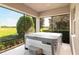 Enclosed lanai featuring a Hot Springs hot tub with backyard golf course views at 5093 Nw 35Th Lane Rd, Ocala, FL 34482