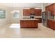 Bright kitchen with an island, modern lighting, and stainless steel refrigerator at 5093 Nw 35Th Lane Rd, Ocala, FL 34482