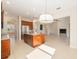 Open-concept kitchen with stainless steel appliances, granite island, and views of the living room at 5093 Nw 35Th Lane Rd, Ocala, FL 34482
