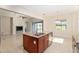 Kitchen island with granite countertops and stainless steel sink, overlooking the Gathering room at 5093 Nw 35Th Lane Rd, Ocala, FL 34482