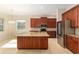 Spacious kitchen featuring a large island, stainless steel appliances, and wooden cabinets at 5093 Nw 35Th Lane Rd, Ocala, FL 34482