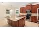 Well-equipped kitchen with granite countertops, stainless steel appliances, and a center island at 5093 Nw 35Th Lane Rd, Ocala, FL 34482