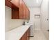 Functional laundry room with modern appliances, ample counter space, and cherry wood cabinets at 5093 Nw 35Th Lane Rd, Ocala, FL 34482
