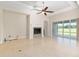 The airy living room has a fireplace, tile floors, and sliders to the outside at 5093 Nw 35Th Lane Rd, Ocala, FL 34482