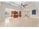 Spacious living room with coffered ceilings, a ceiling fan, and an open-concept kitchen at 5093 Nw 35Th Lane Rd, Ocala, FL 34482