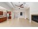Open-concept living room with fireplace, tile floors, and adjacent kitchen at 5093 Nw 35Th Lane Rd, Ocala, FL 34482