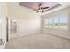 Spacious main bedroom with tray ceiling, fan, plantation shutters and ensuite bathroom at 5093 Nw 35Th Lane Rd, Ocala, FL 34482