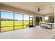 Large screened lanai with ceiling fan and hot tub overlooking the backyard at 5093 Nw 35Th Lane Rd, Ocala, FL 34482