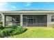 Exterior view of screened in lanai surrounded by lush landscaping at 5093 Nw 35Th Lane Rd, Ocala, FL 34482
