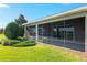 Back exterior with screened in lanai, lush green lawn and landscaping at 5093 Nw 35Th Lane Rd, Ocala, FL 34482