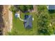 An aerial view shows this new home on a spacious lot with a modern gray roof and complementary green lawn at 5388 Nw 9Th St, Ocala, FL 34482