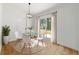 Cozy dining area features modern chandelier, round table, and sliding glass door to yard at 5388 Nw 9Th St, Ocala, FL 34482