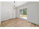 Minimalist dining area with light fixture and a sliding glass door for outdoor access at 5388 Nw 9Th St, Ocala, FL 34482