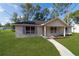 Attractive home featuring a manicured lawn, sidewalk and charming blue shutters at 5388 Nw 9Th St, Ocala, FL 34482