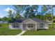Charming single-story home with blue shutters, well-manicured lawn and a blue sky at 5388 Nw 9Th St, Ocala, FL 34482