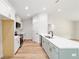 Modern kitchen with white cabinets, stainless steel appliances, and a large island with a sink at 5388 Nw 9Th St, Ocala, FL 34482