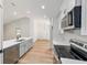 Bright kitchen features modern appliances, grey cabinets, and stylish hardware with wood flooring at 5388 Nw 9Th St, Ocala, FL 34482