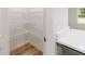 A well-organized walk-in pantry offers ample storage with metal shelving and wood flooring at 5388 Nw 9Th St, Ocala, FL 34482