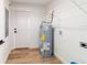 Utility room area with water heater, shelving, washer-dryer hookups, and vinyl flooring at 5388 Nw 9Th St, Ocala, FL 34482