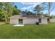 A well-maintained backyard with a sliding glass door and green grass at 5400 Nw 9Th St, Ocala, FL 34482