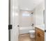 Well-lit bathroom featuring a tub, shower, and wood-finished vanity at 5400 Nw 9Th St, Ocala, FL 34482