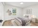 Cozy bedroom with a large window, hardwood floors, and neutral decor at 5400 Nw 9Th St, Ocala, FL 34482