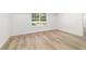 Light filled bedroom with a large window and sleek wood-look flooring at 5400 Nw 9Th St, Ocala, FL 34482