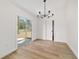 Bright dining area featuring sliding glass doors and modern chandelier at 5400 Nw 9Th St, Ocala, FL 34482