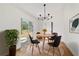 Cozy dining room with modern lighting, a round wooden table, and access to the backyard at 5400 Nw 9Th St, Ocala, FL 34482