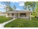 Lovely single-story home with a covered front porch and green lawn at 5400 Nw 9Th St, Ocala, FL 34482
